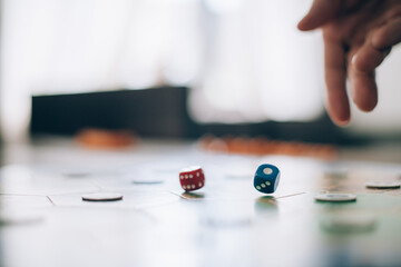 Board game and hands roll dice close-up.