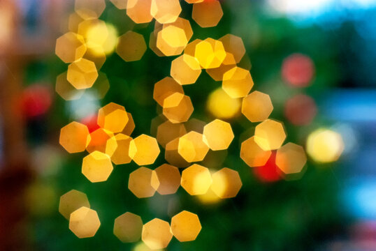 Defocused ligths of Christmas tree. Christmas background, image blur colorful bokeh.