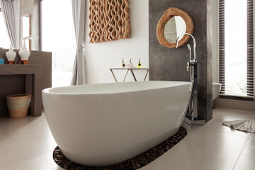 Modern new bathroom interior design with white stone bathtub in new villa or hotel Modern building.