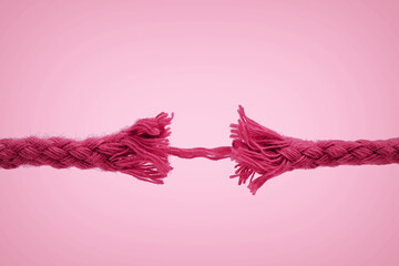 Nearly broken rope on pink background - Concept of violence against women - obrazy, fototapety, plakaty