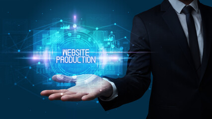 Man hand holding WEBSITE PRODUCTION inscription, technology concept
