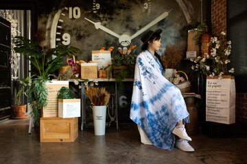 Traveler thai young women wear indigo tie dye paint shawl and scarf posing portrait sit read...