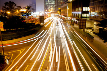 Fototapeta na wymiar Light trails of car traffic in downtown district of Hong Kong city at night