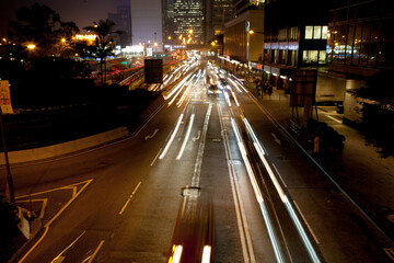 Fototapeta na wymiar Light trails of car traffic in downtown district of Hong Kong city at night