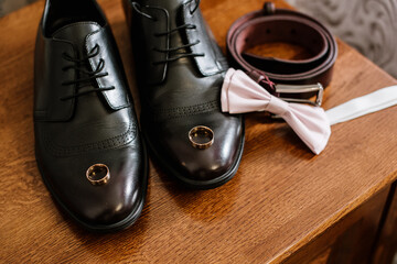 Grooms shoes with bouquet, rings and wedding accessories