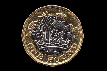 New one pound British coin of England UK introduced in 2017 which show emblems of each of the nations cut out and isolated on a black background stock photo image