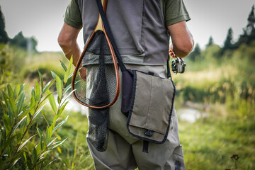 The fisherman is ready to go fishing. He's going to catch trout.