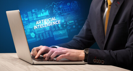Businessman working on laptop with ARTIFICIAL INTELLIGENCE inscription, cyber technology concept