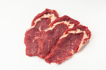 Three raw beef steaks on white background