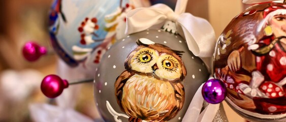Beautiful balls for traditional Christmas tree hanging on a wooden stand in the Mall. Banner.