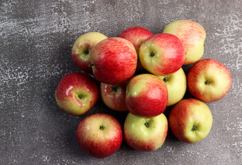 Ripe red green apples on a dark background. Top view, flat lay