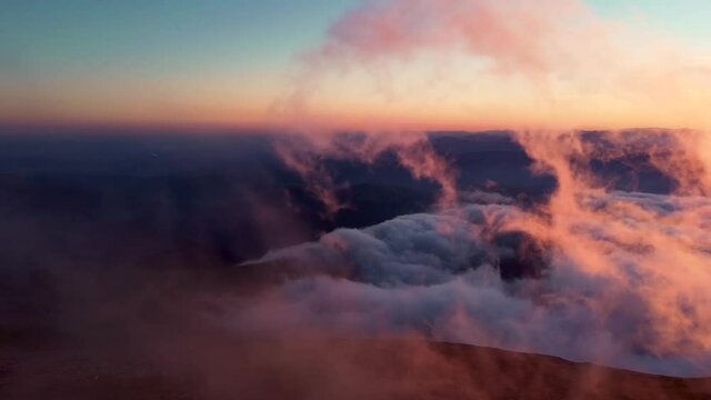 Amazing sunset from the top of the mountains with fog in autumn season aerial video