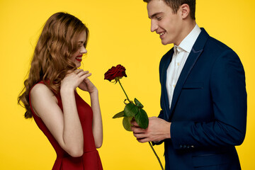 Couple in love man and woman with red rose classic costume red dress model