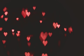 Defocused abstract red color heart shaped bokeh lights background. orange. valentine's day concept. space for text