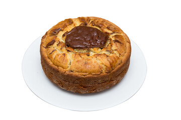round shaped home baked golden brown pure butter cake topped up with pure chocolate with a crispy texture and super soft placed in a white ceramic plate on white background