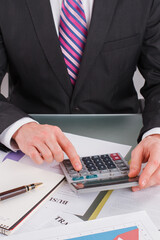 Close up of businessman or accountant using calculator. Accountant checking the numbers. Calculations, audit and financial analysis concept.