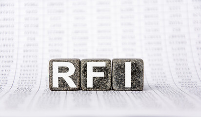 three stone cubes on the background of white financial statements, tables with the word RFI Request for information. Strong business concept