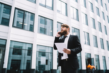 Confident businessman having conversation on smartphone