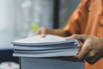 Office workers employee holding stacks of lot documents report papers waiting be managed on desk in...