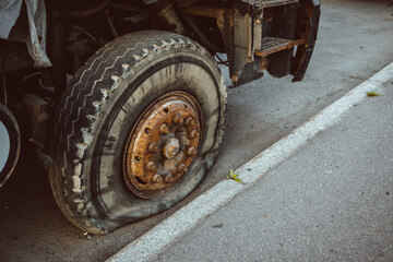 Fototapeta na wymiar broken wheel at the truck heavy cargo tyre transportation problems blow