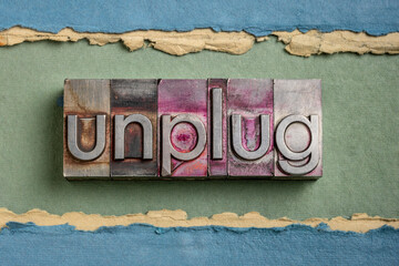 unplug  - lifestyle or information overload concept  - word in vintage gritty letterpress metal...