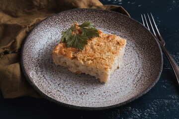cauliflower casserole on a plate and dark background