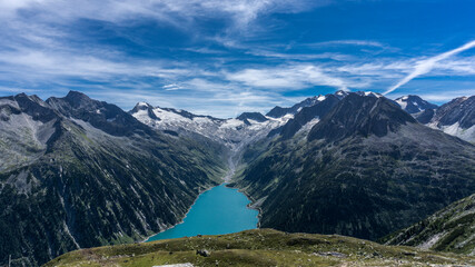 Stunning view to crystal clear blue lake in Austria alpine mountains with blue sky and glaciar