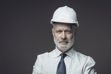 Smiling businessman wearing a safety helmet