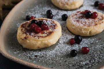 cottage cheese pancakes with wild berries and powdered sugar
