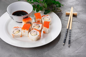 Untraditional Rolls with cucumber, omelet and ham on a plate. Sushi.