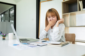 Young Business women are stressing about numbers with calculator and laptop at office ,a stress-to-work concept.
