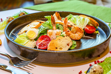 Salad of shrimp, olives, tomato, lettuce and quail eggs. Top view. Selective focus. Super short focus.
