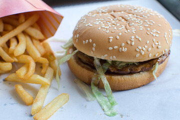 A delicious burger on a white plate