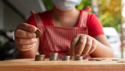 Food vendor woman hands counts the money or saving money.