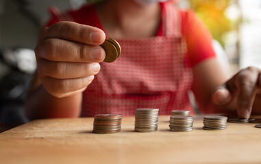 Food vendor woman hands counts the money or saving money.