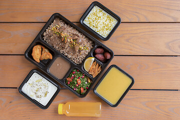 Take away lunch box meal of Arabic food included starter, main course, dessert and drink. Order lunch box. Stay at home and eat healthy. Cope space.