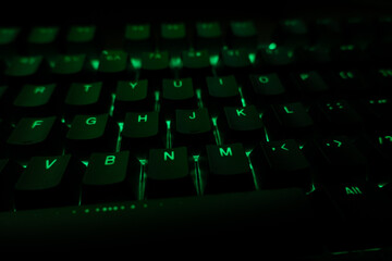 Close-up of green backlit keyboard. Gaming keyboard.