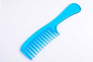 Blue plastic comb on a white background.