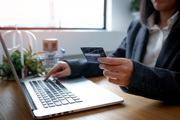 Close up of Business Woman Hand using credit card for work in the office room, business,home workSME,shopping online,marketing, freelance concept.