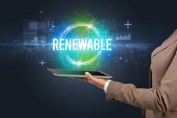Close-up of a touchscreen with RENEWABLE inscription, new technology concept