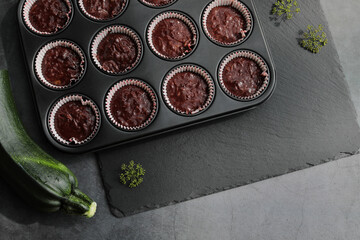 Preparation homemade zucchini muffins with chocolate. Ketogenic diet concept. Flat lay. Copy space.