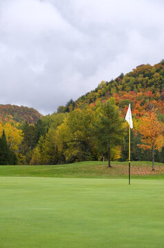 White Golf Flag With Autumn Colors In The Mountains