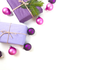 Christmas gift boxes with pink and purple decorations on white background. Christmas border. Flat lay. Copy space.