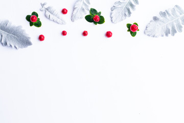 red and white,Christmas frame made of fir branches, red berries. Christmas wallpaper. Flat lay, top view, copy space