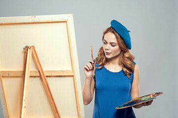 Woman artist blue beret drawing palette easel art hobby Creative
