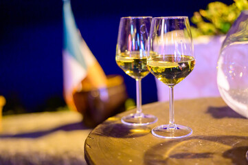 Two glasses of cold dry white wine served outdoor in cafe at night in Italy