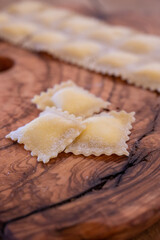 Handmade uncooked fresh ravioli with four cheeses filling, tasty vegetarian food