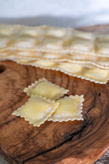 Handmade uncooked fresh ravioli with four cheeses filling, tasty vegetarian food