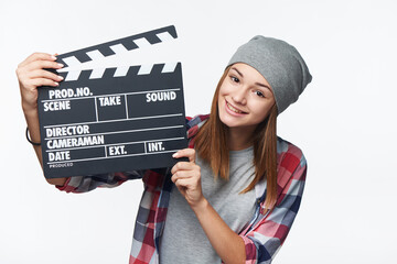 Smiling teen girl holding clap board