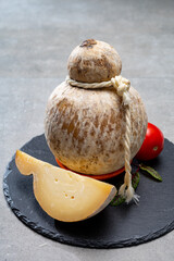 Italian semi hard matured caciocavallo cheese, handmade and aged in natural underground caves in...